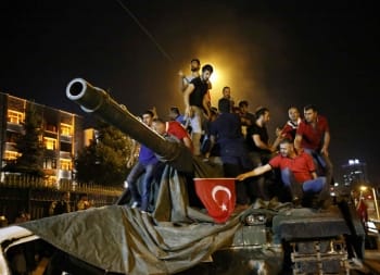 People stand on a Turkish army tank in Ankara, Turkey July 16, 2016.   REUTERS/Tumay Berkin