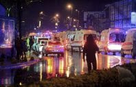 Medics and security officials work at the scene after an attack at a popular nightclub in Istanbul, early Sunday, Jan. 1, 2017. Turkey's state-run news agency says an armed assailant has opened fire at a nightclub in Istanbul during New Year's celebrations, wounding several people.(IHA via AP)