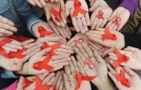 University students hold red ribbons at a photo opportunity during an HIV/AIDS awareness rally on World AIDS day in Chengdu, Sichuan province December 1, 2009. REUTERS/Stringer (CHINA HEALTH SOCIETY) CHINA OUT. NO COMMERCIAL OR EDITORIAL SALES IN CHINA