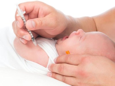 Doctor vaccinating child baby flu injection shot i